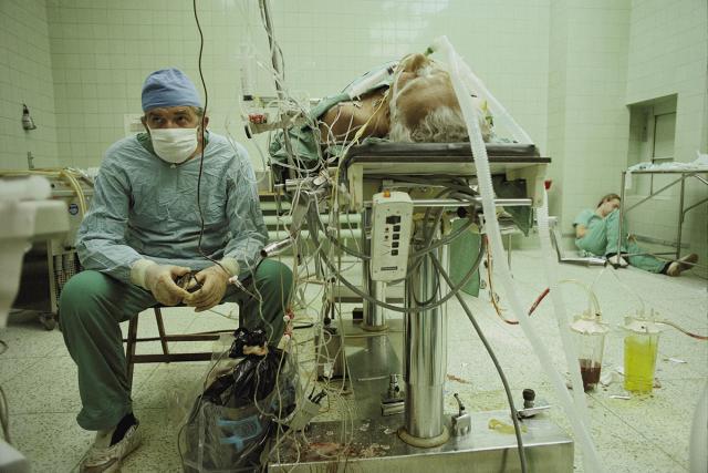 3 Heart surgeon after 23 hour long successful heart transplant His assistant is sleeping in the corner JamesStanfield